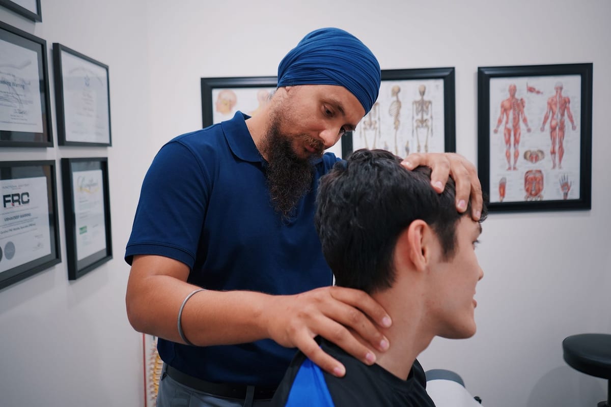 A therapist working through a patient's neck and shoulder by hand